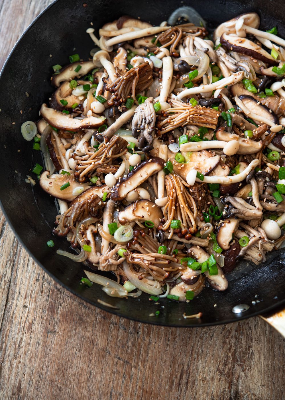 Savory stir-fried mushrooms in a pan with garlic and onion.