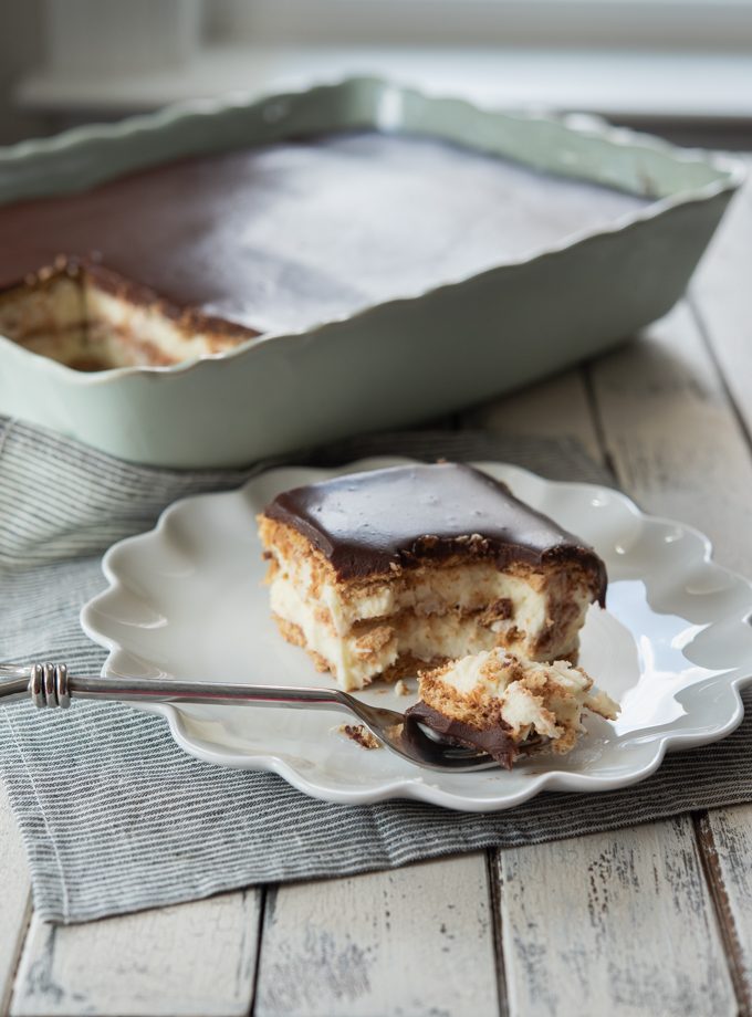 No-bake eclair cake with kitchen-made pastry cream, graham crackers, and chocolate ganache.