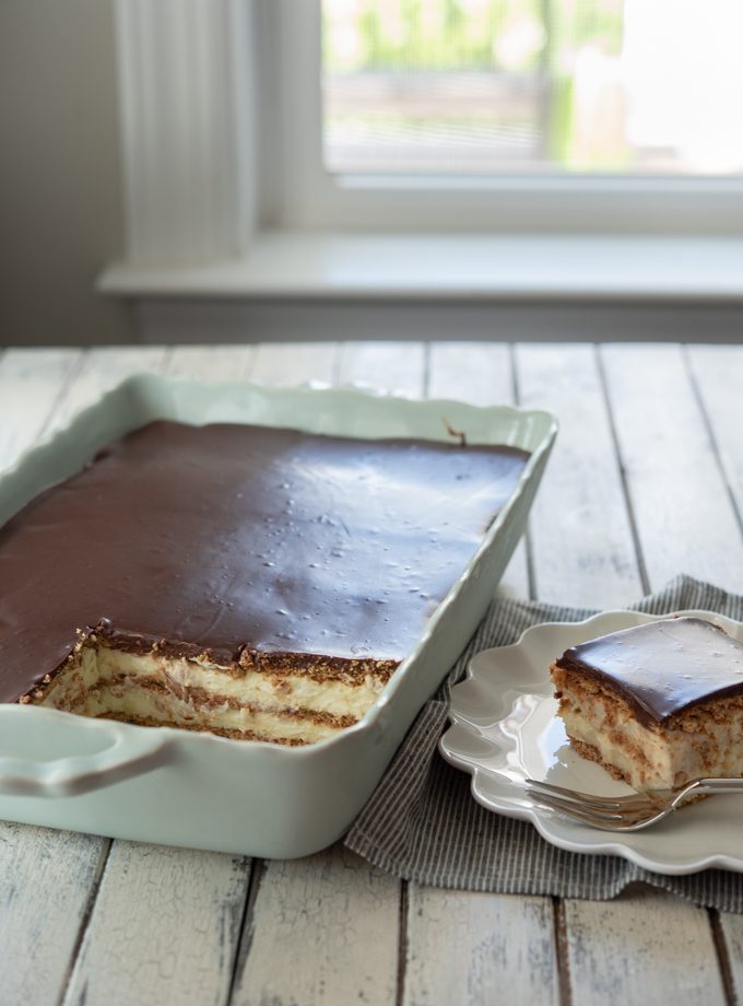 No-bake eclair cake made from scratch with graham crackers, vanilla custard, and chocolate ganache