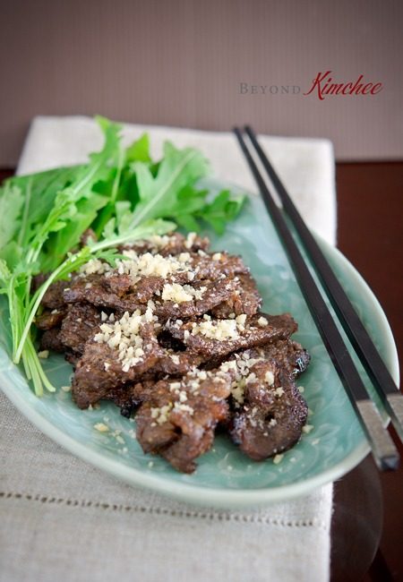 Nuhbiani garnished with pine nuts in a serving dish.