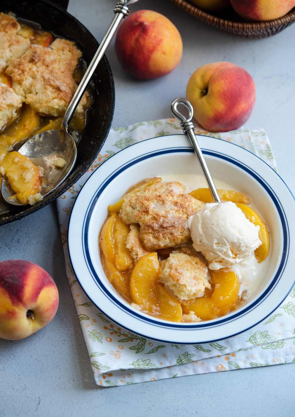 Old-fashioned peach cobbler topped with a scoop of vanilla ice cream
