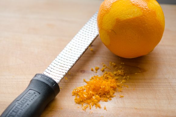 Grating fresh orange zest with a grater