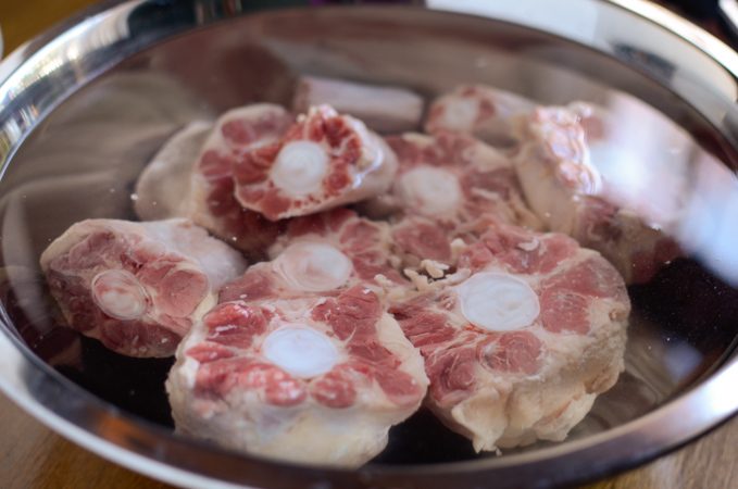 Ox Tail bones are soaking in the water.
