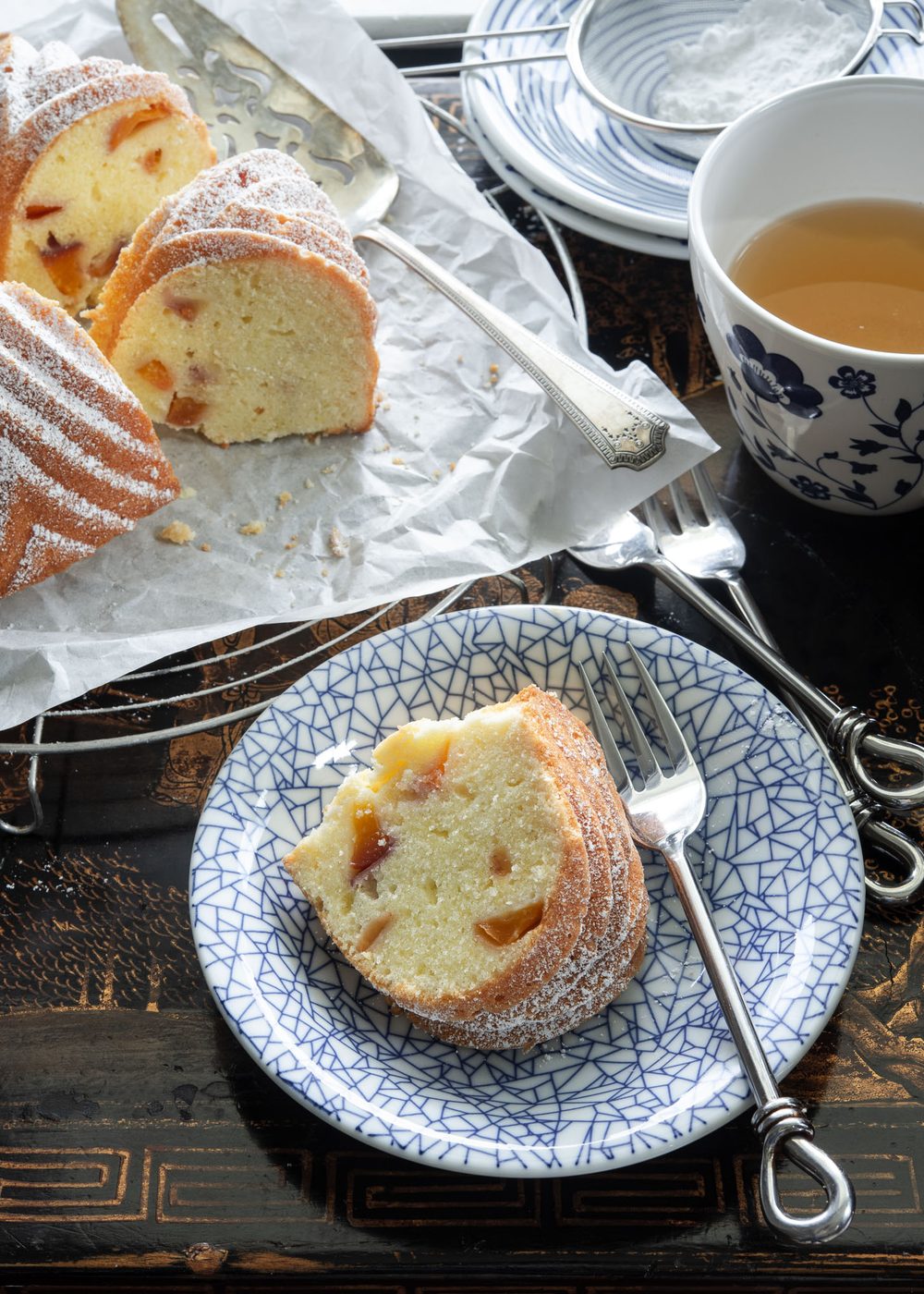 Peach pound cake served on a blue plate.