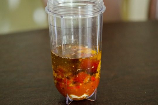 Chili and other ingredient for peri-peri sauce is combined in a mini blender.