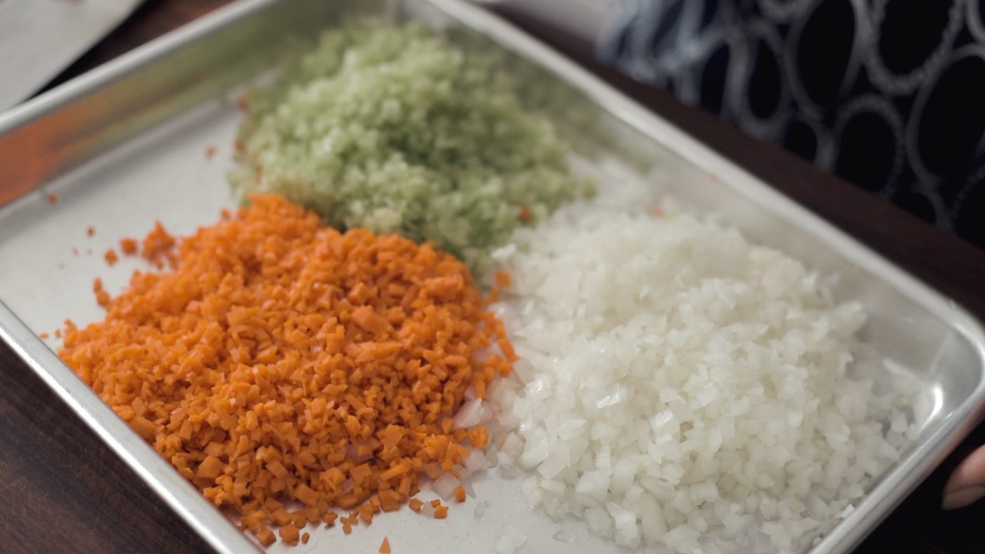 Minced onion, carrot, celery on a tray.