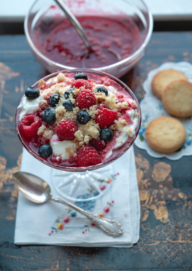 Raspberry fool topped with shortbread cookie crumbs.