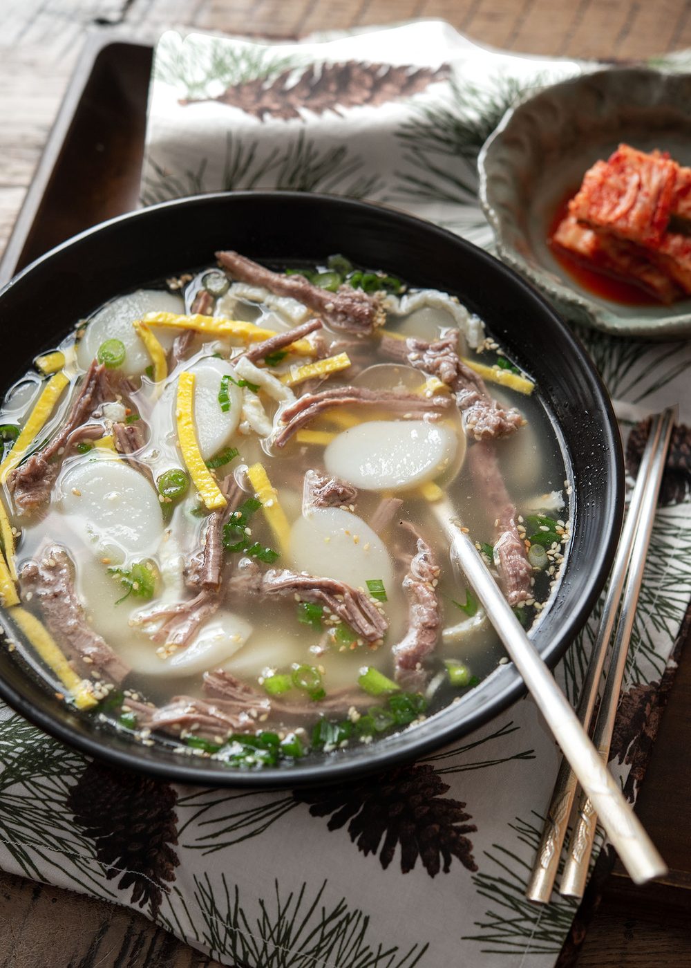 Korean rice cake soup with clear beef broth and tender sliced tteok