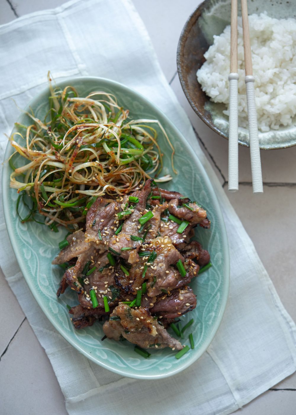 Korean doenjang pork (maekjeok) served with green onion salad and rice.
