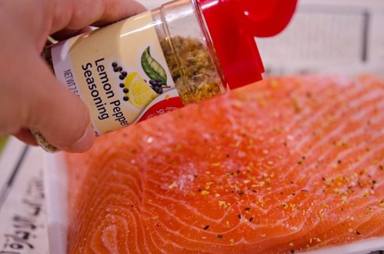 Lemon pepper sprinkled over salmon.