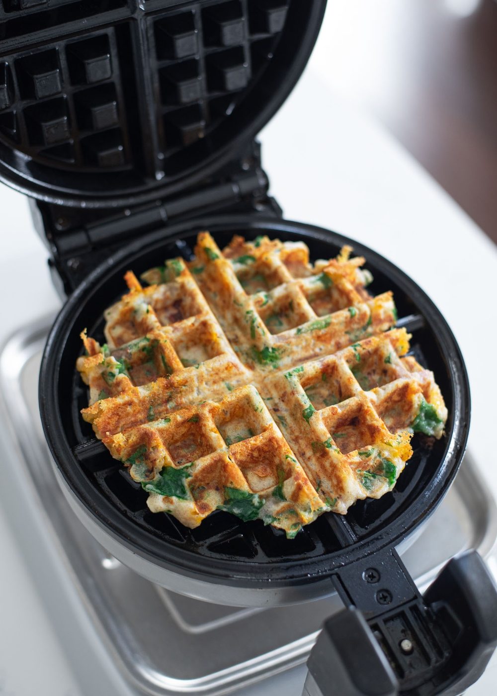 Golden savory waffles just cooked in a waffle maker.