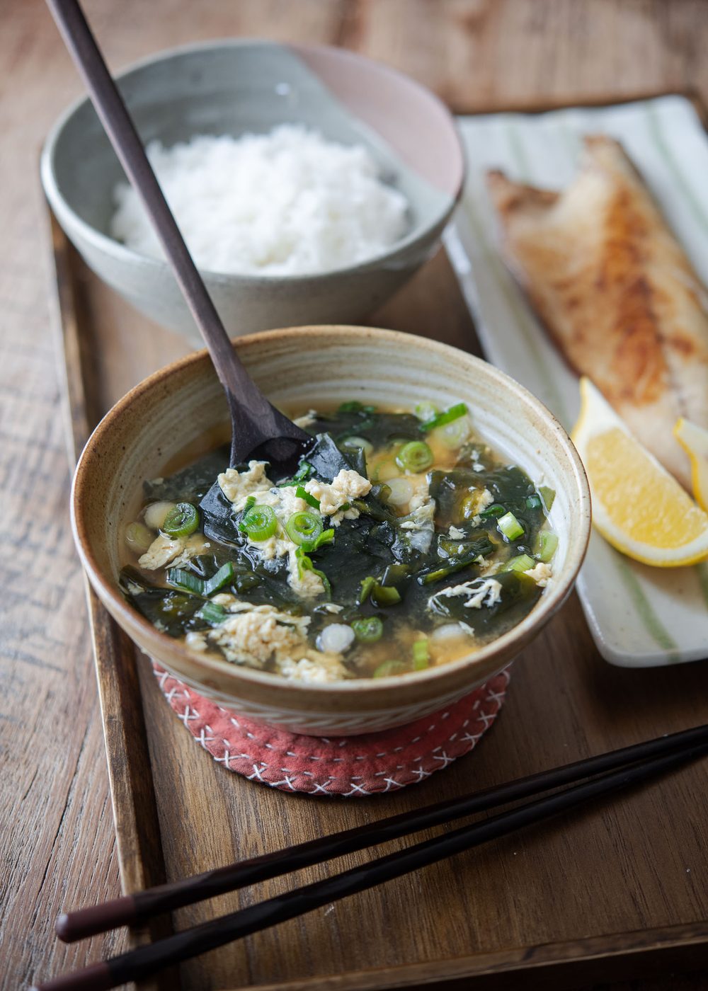 Seaweed egg drop soup is served with rice and fish.