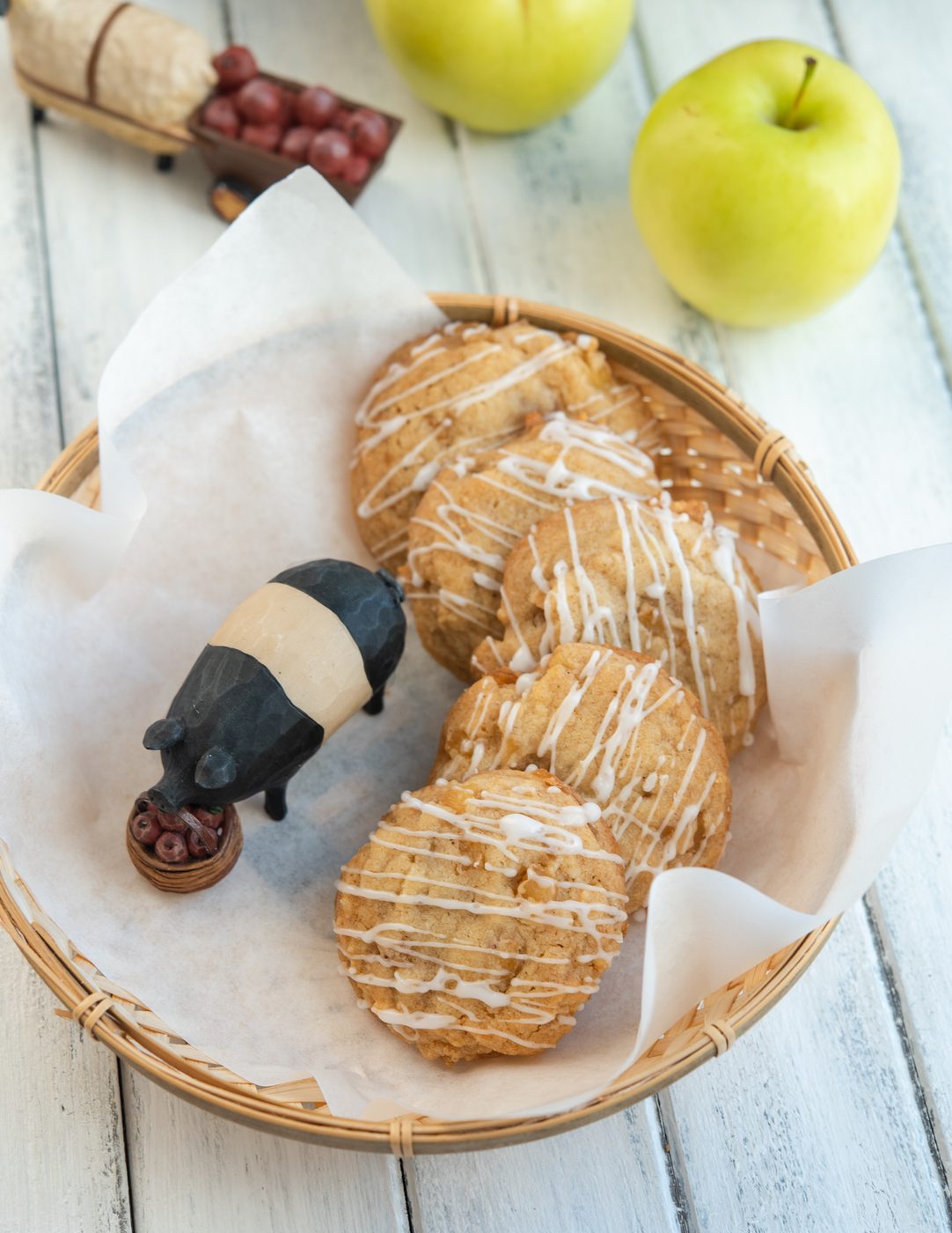 Fall apple cookies served in a lined basket with apples nearby