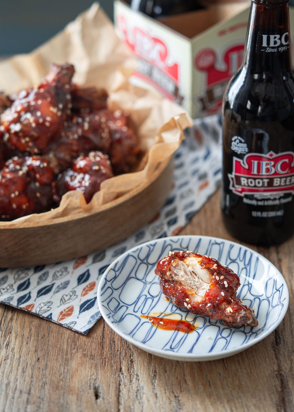 Bite of crispy Korean fried chicken showing juicy inside with spicy yangnyeom glaze
