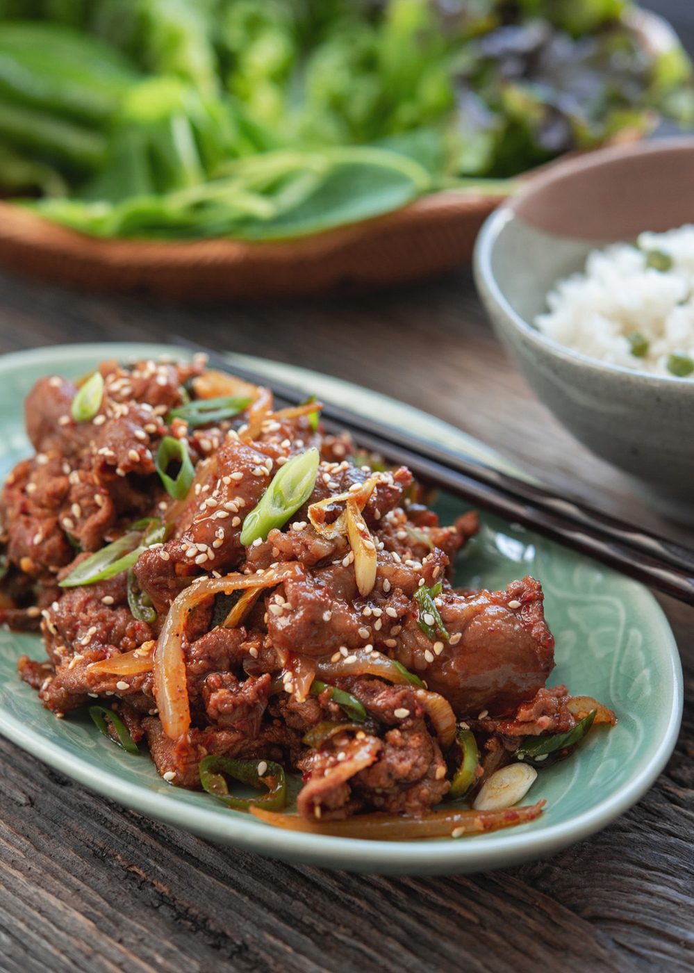 Spicy pork bulgogi glazed in gochujang sauce with sesame seeds and green onion