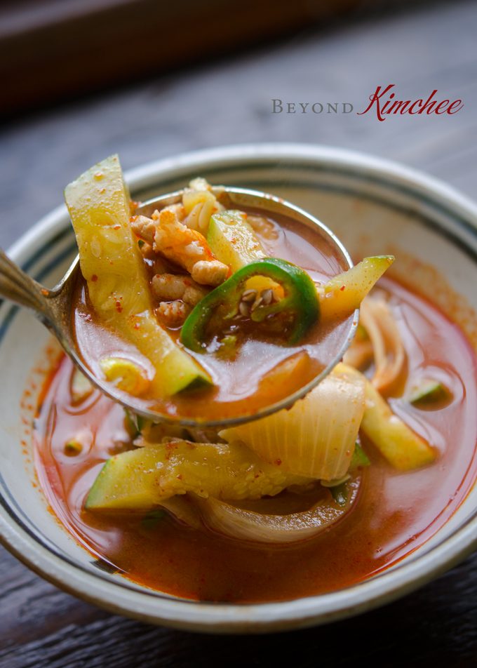 A ladleful of gochujang jjigae with pork and Korean zucchini