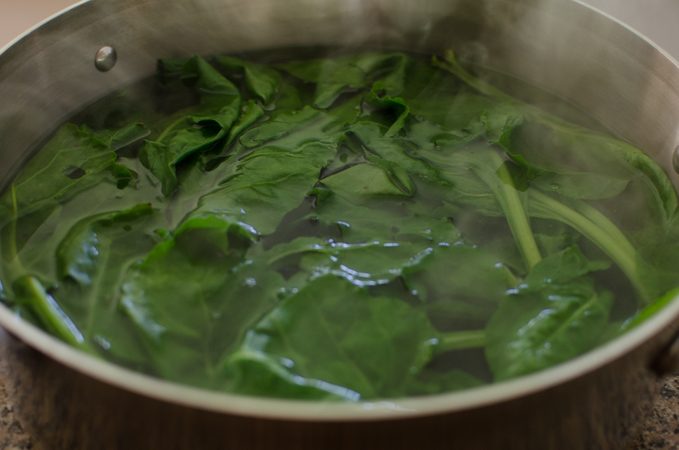 Blanching Swiss chard in boiling water.