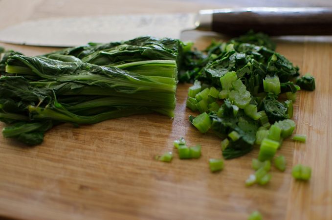 Chopping blanched Swiss chard.