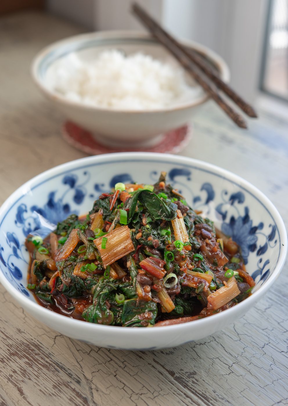 Chineses style swiss chard stir-fry is served with rice.