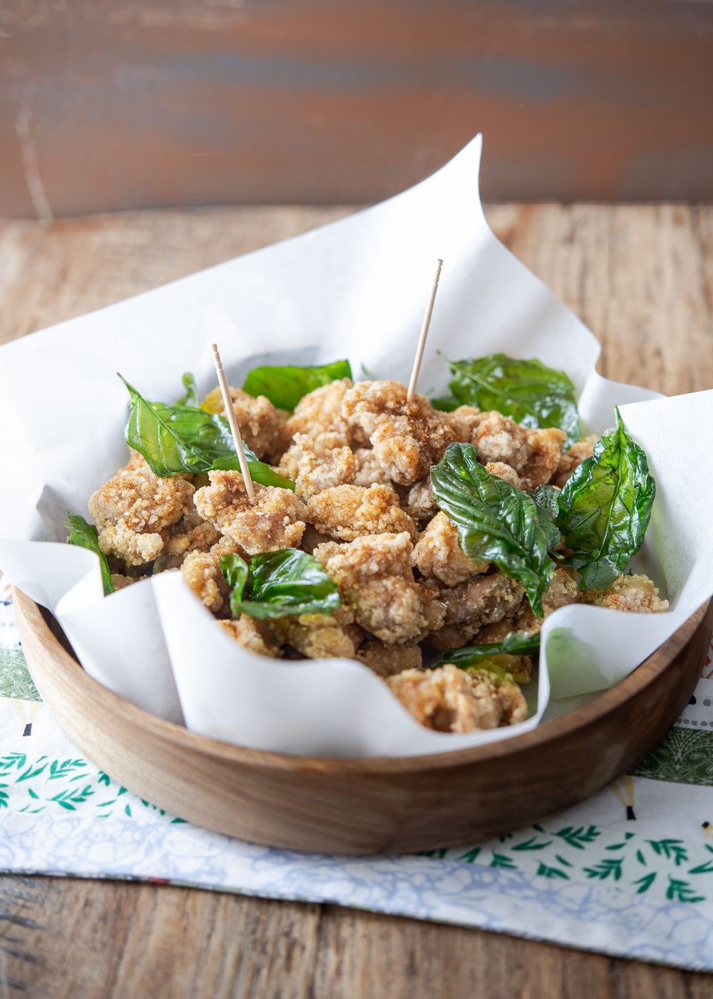Taiwanese popcorn chicken is served in a container with toothpicks.