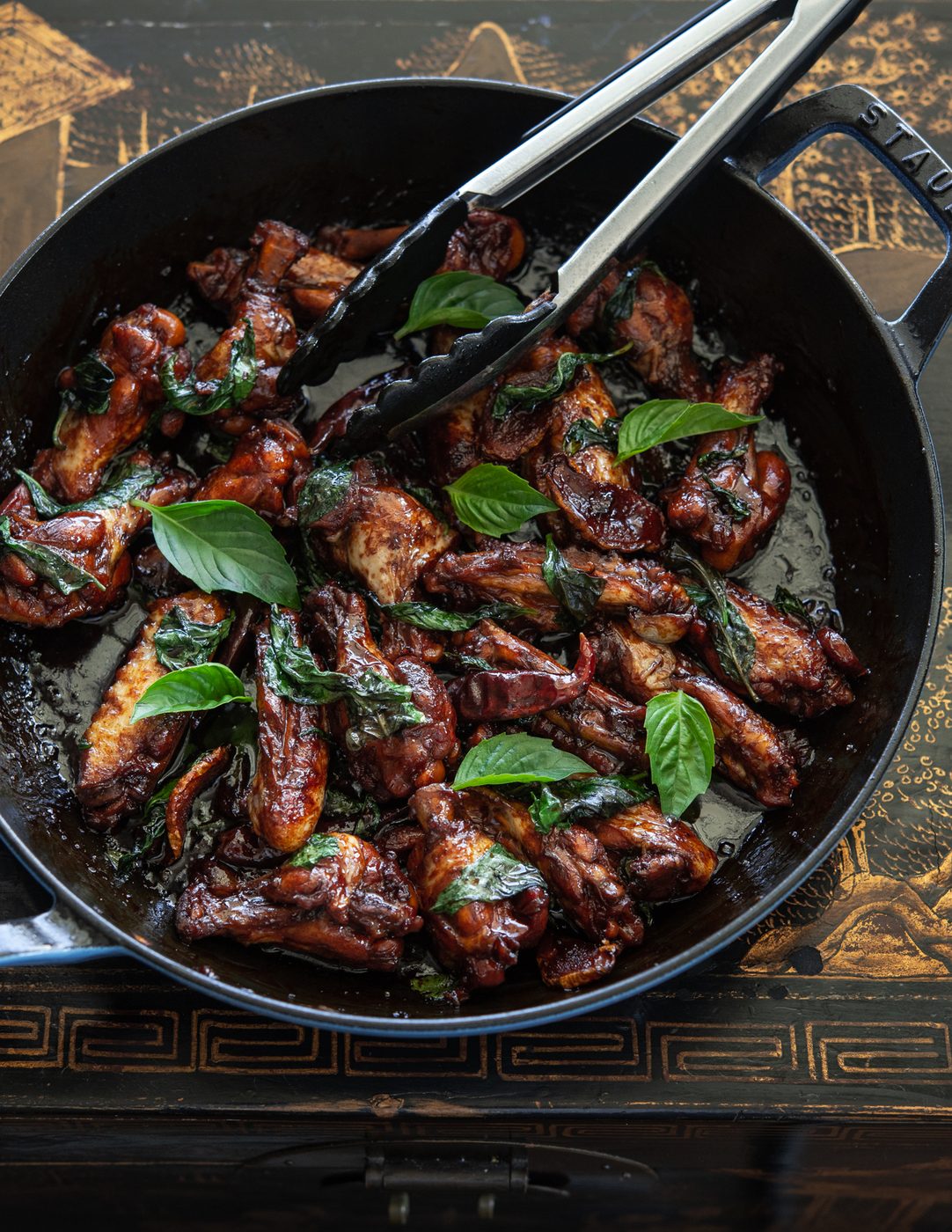 Taiwanese three cup chicken (san bei ji) is garnished with Thai basil leaves.