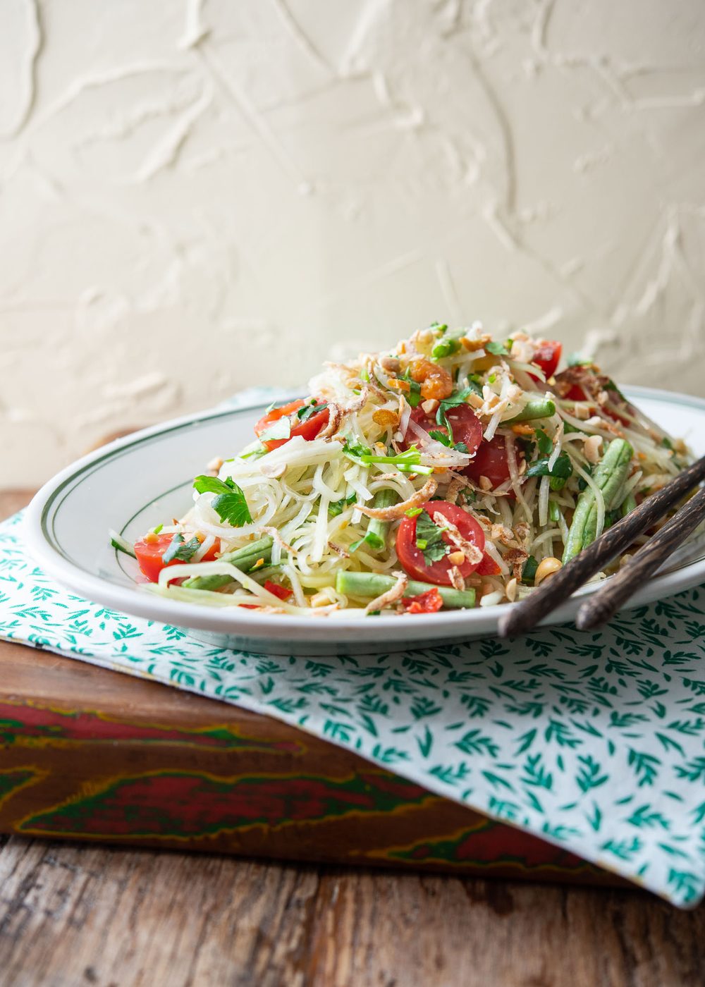 Plate of Thai papaya salad (Som Tam) topped with peanuts