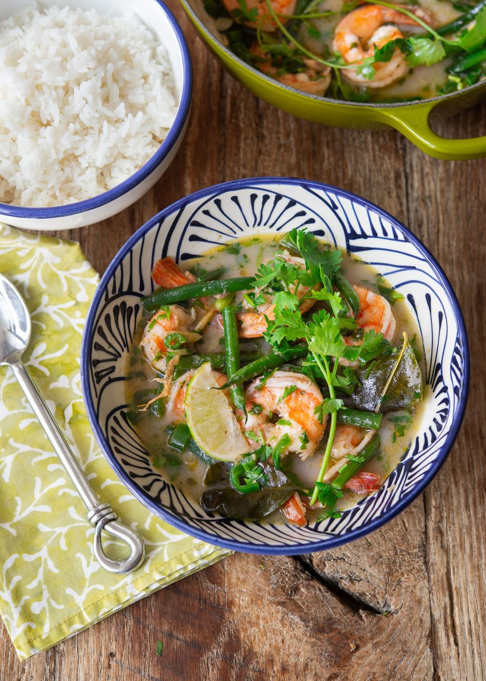 Top view of Thai green shrimp curry bowl with rice.