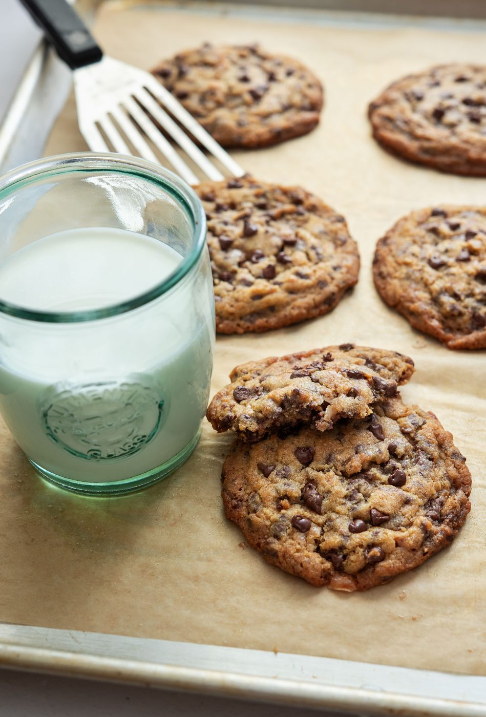 A glass of milk served with cookies.