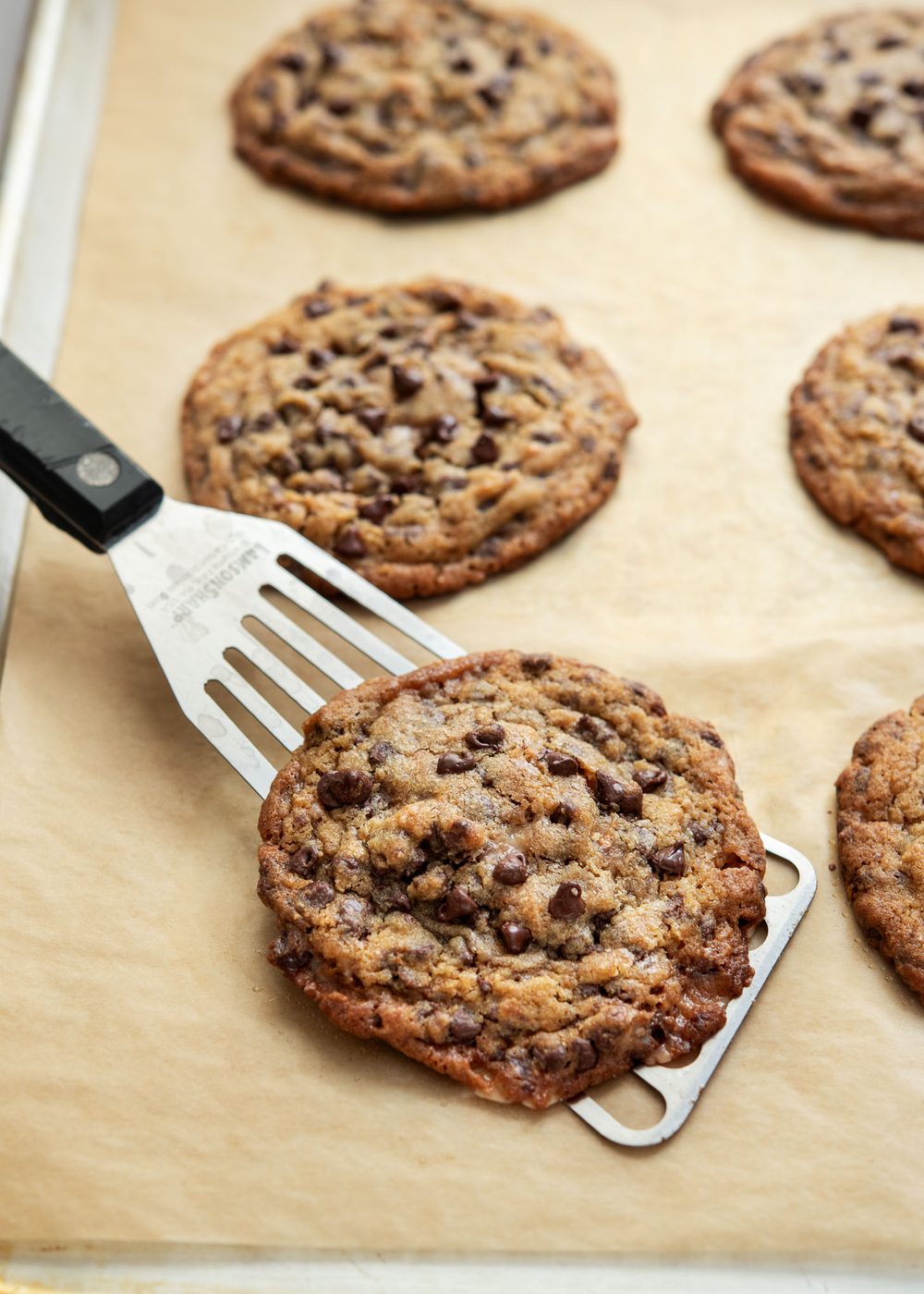 Toffee chocolate chip cookies on a baking sheet.