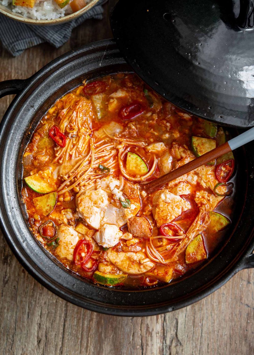 Spoonful of tuna sundubu jjigae in a bubbling pot