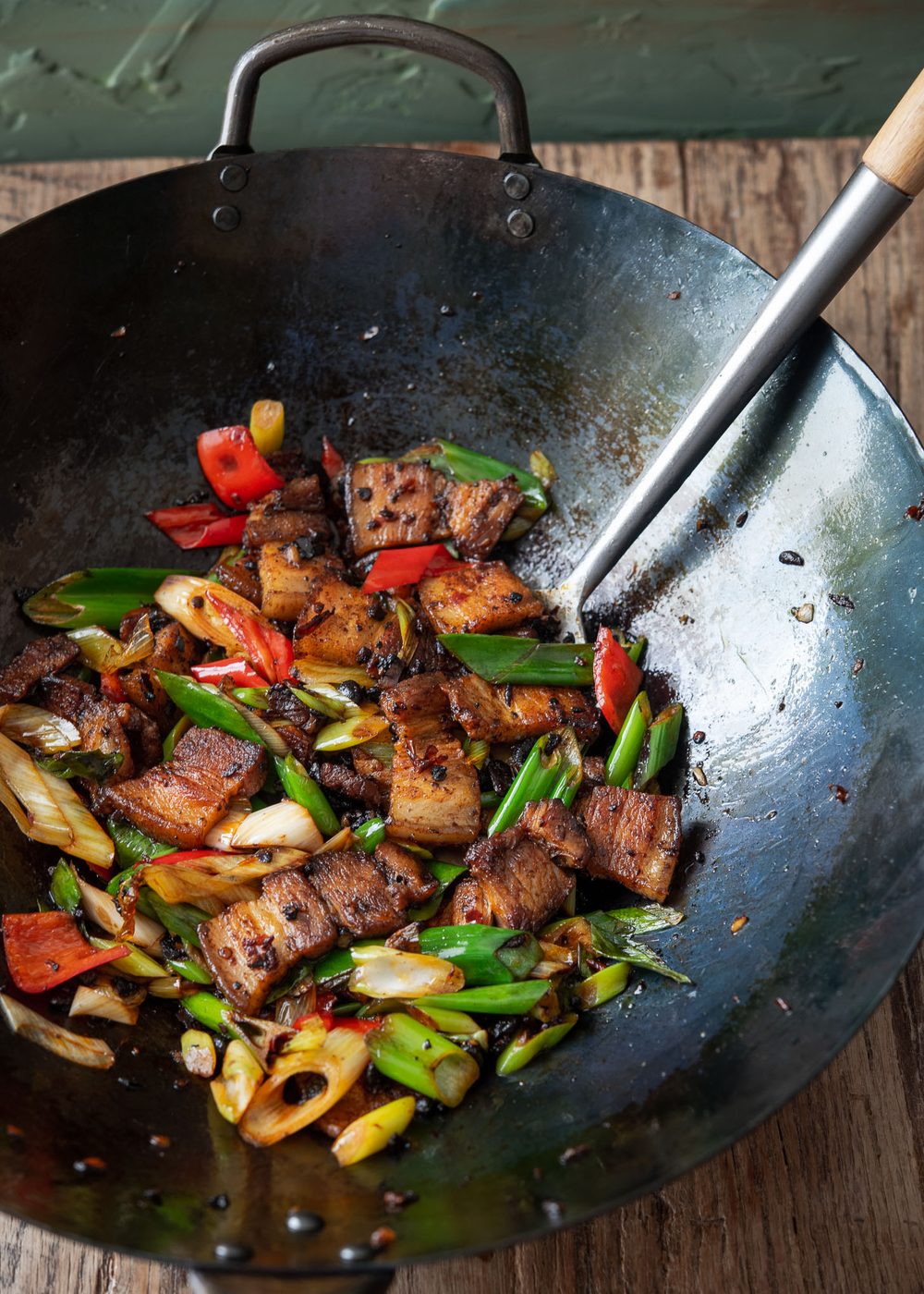 Twice cooked pork (Sichuan pork stir-fry) prepared in a Chinese wok.