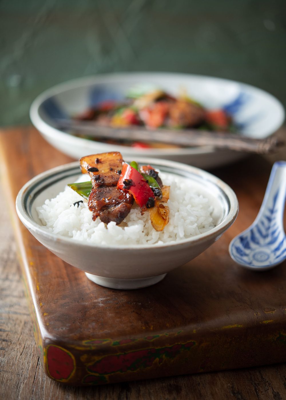 Sichuan style twice cooked pork belly served over a bowl of white rice.