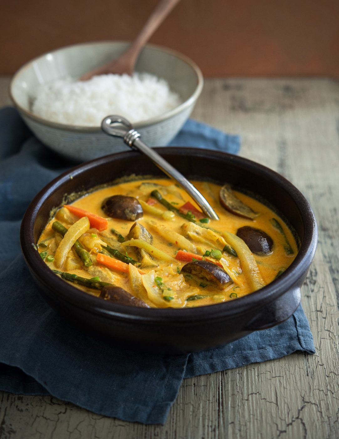 A bowl of vegetable curry with rice.
