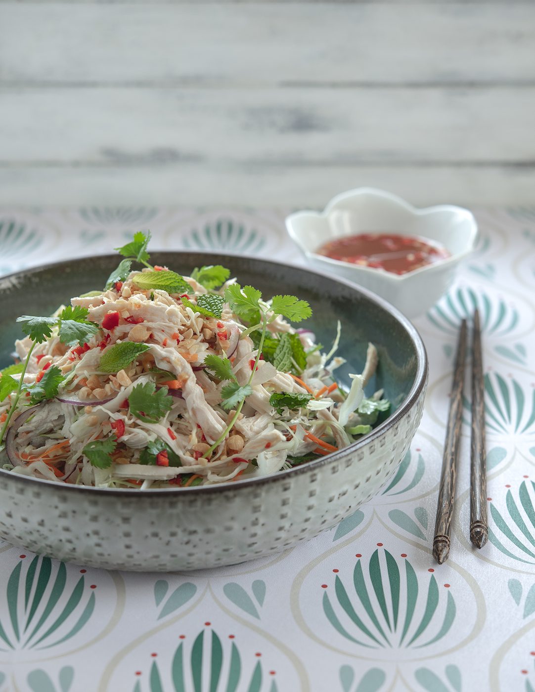 Plated Vietnamese chicken salad topped with fresh cilantro and mint