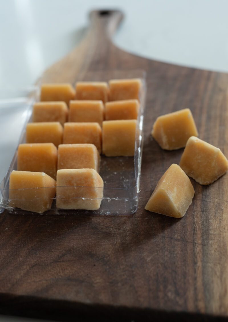Palm sugar cubes arranged on a wooden board