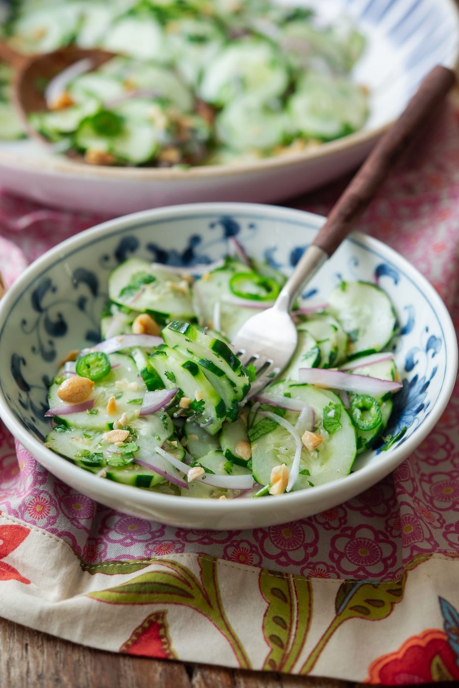 A bowl of Vietnamese cucumber salad with a fork.