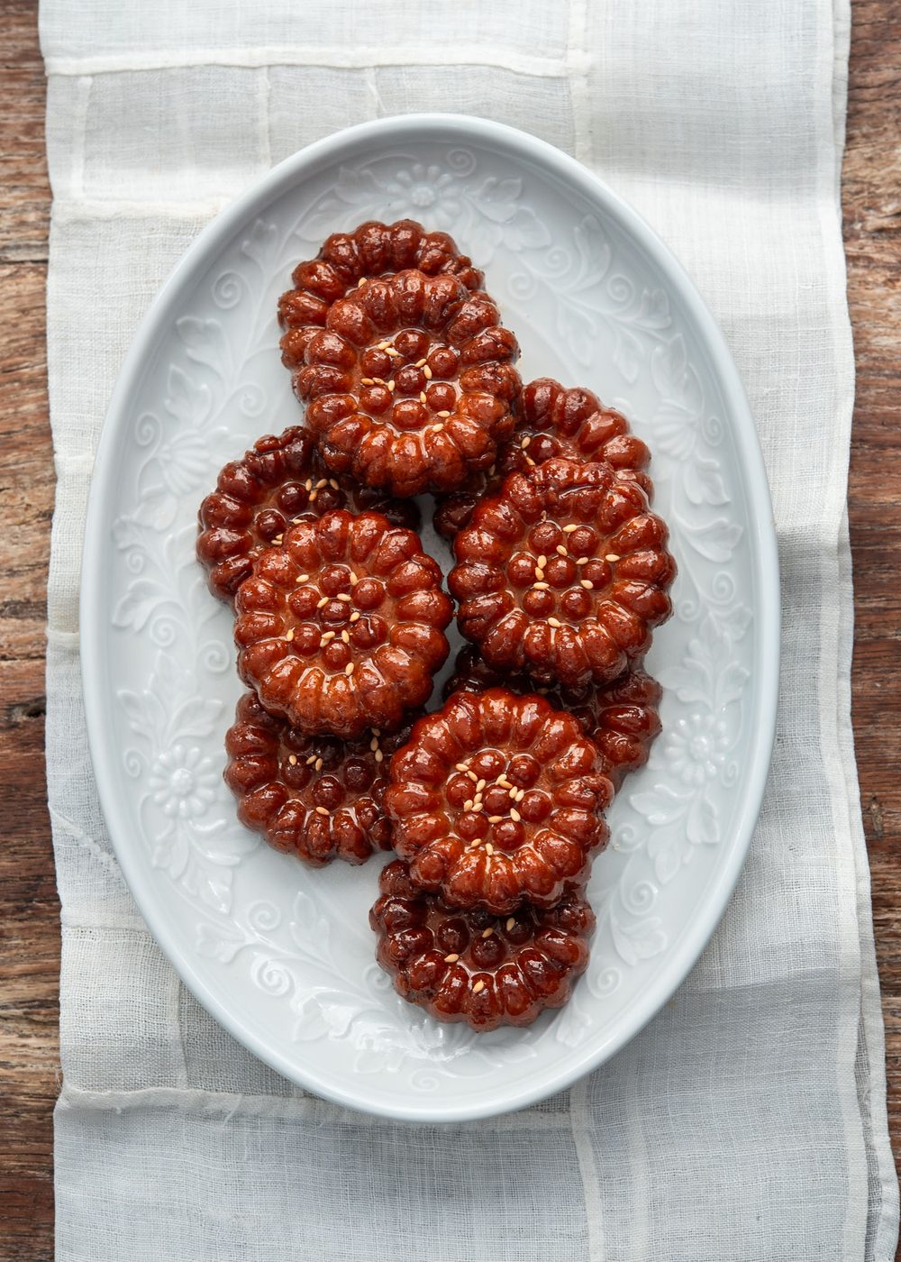 Yakgwa Korean honey cookies arranged on a white plate