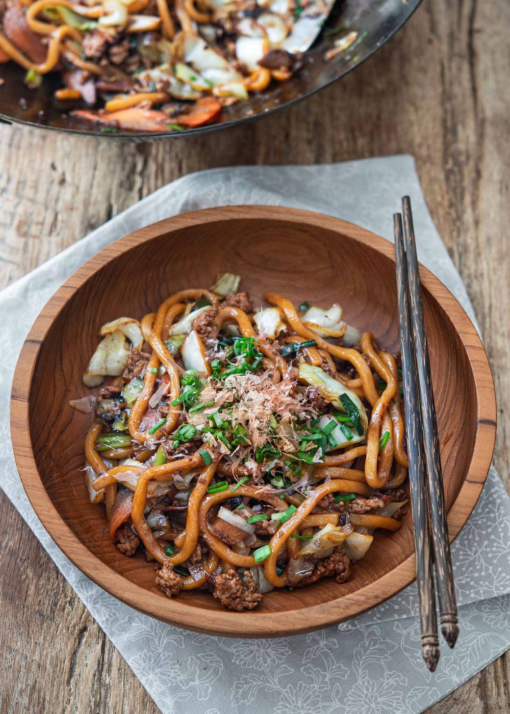 Japanese yaki udon noodles in a serving bowl with chopsticks.