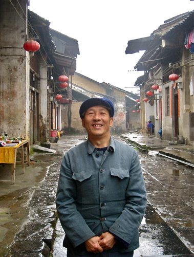 A man wearing Mao suit.