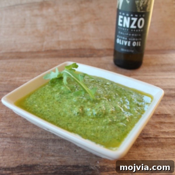 Robust Arugula Walnut Blue Cheese Pesto 7 Finished Arugula Walnut Blue Cheese Pesto drizzled over a grilled tri-tip steak, a perfect culinary pairing.