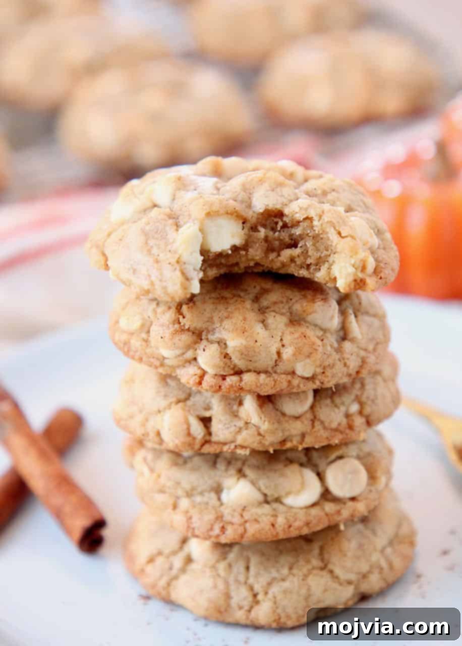 Autumn White Chocolate Pumpkin Delights 2 Stacked up pumpkin spice cookies on plate with cinnamon sticks