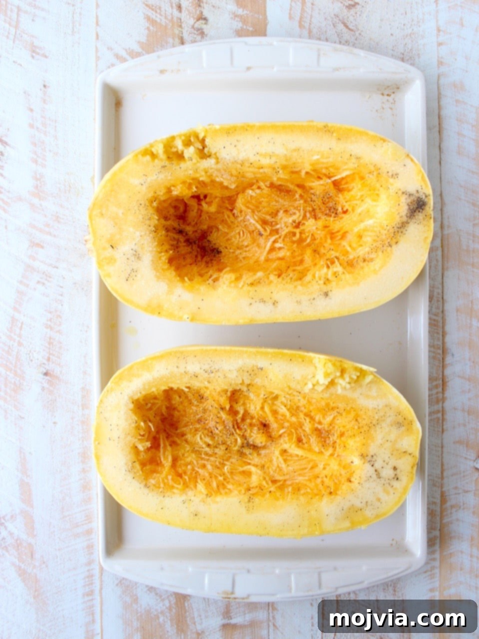 Savory Harvest Squash Boats 5 Spaghetti squash sliced in half on baking sheet