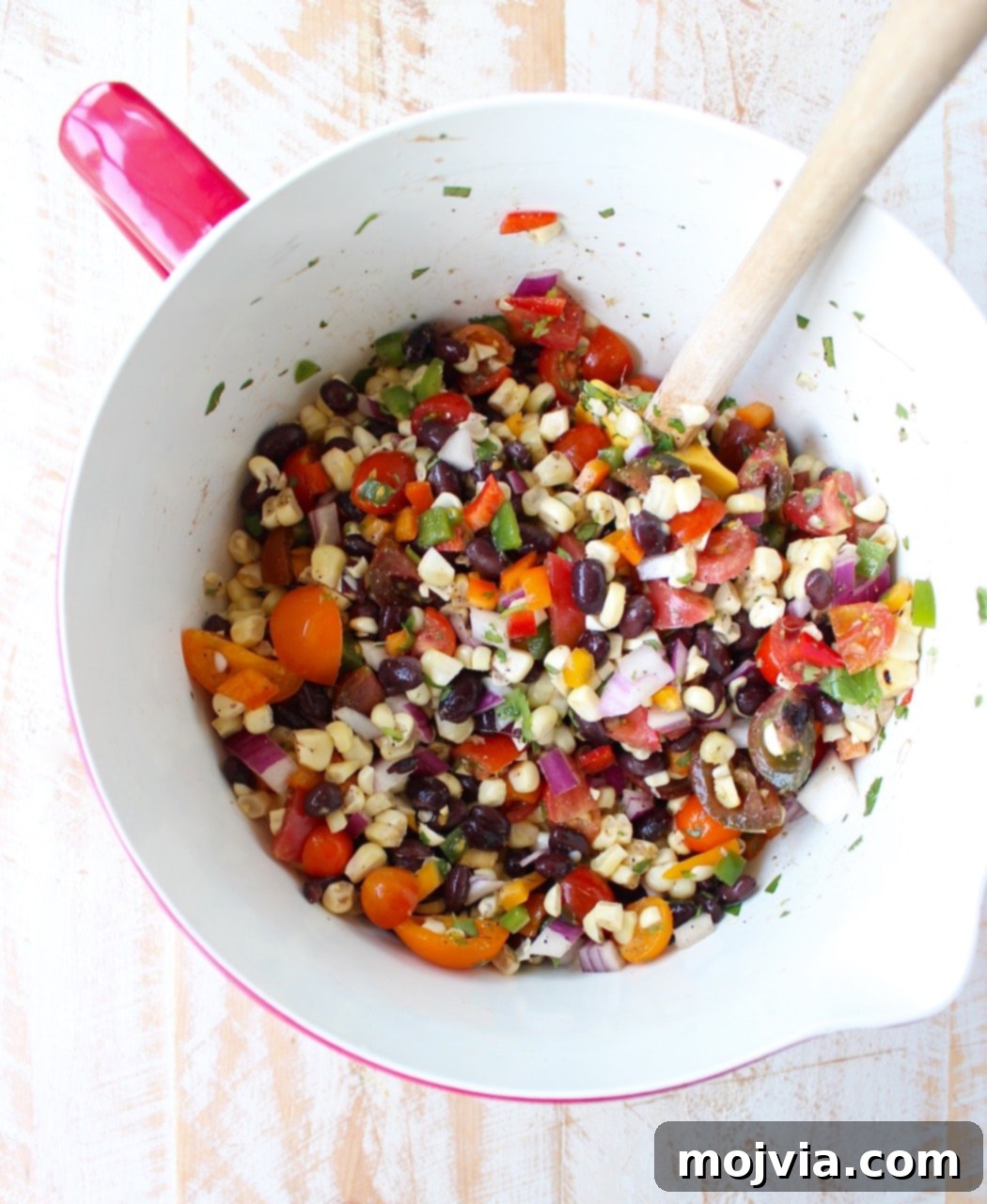 Savory Harvest Squash Boats 6 Black bean corn relish in large mixing bowl with spatula