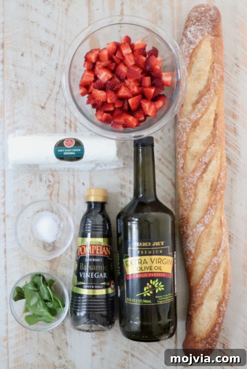 Strawberry Bliss Bites 3 A beautiful flat lay photograph showcasing all the fresh ingredients for strawberry balsamic bruschetta, including ripe strawberries, fresh basil, a baguette, olive oil, and goat cheese, neatly arranged on a white wooden board.