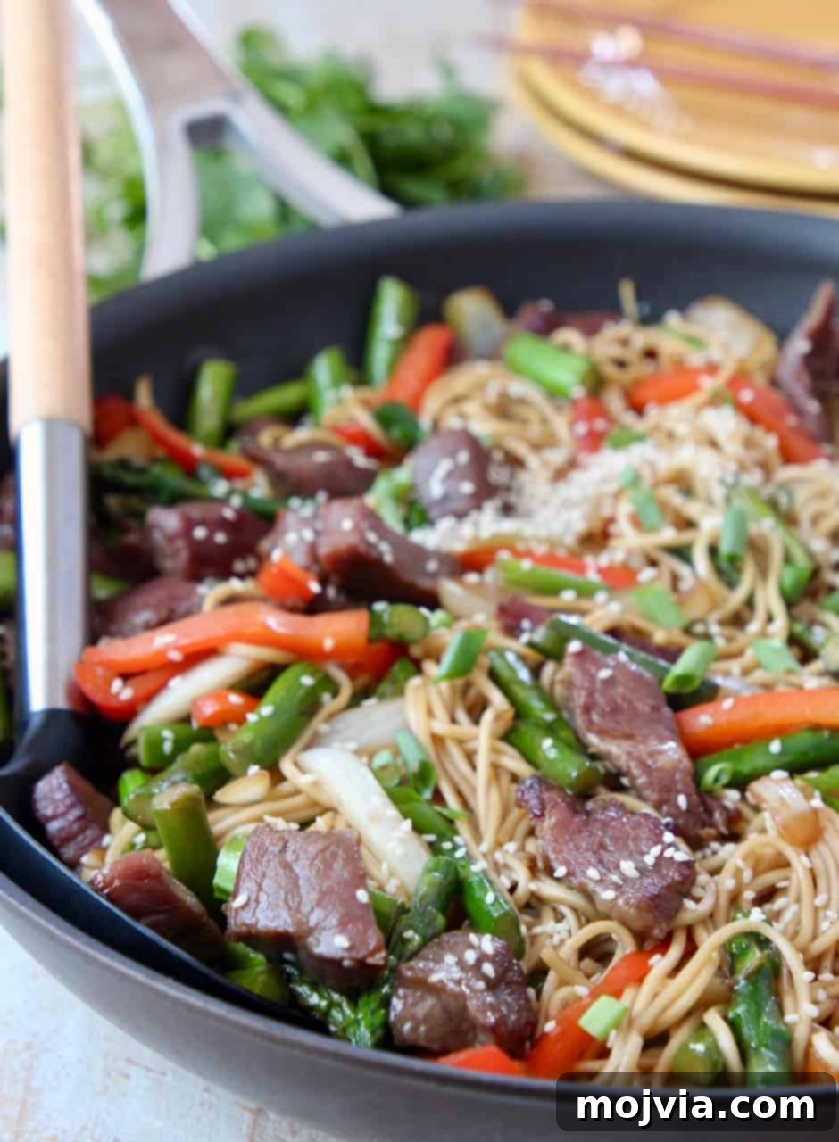 Perfect Beef Stir Fry 6 beef stir fry with noodles in skillet with serving spoon