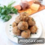This delicious recipe for gluten free sausage balls combines creamy mashed sweet potatoes with homemade gluten free bisquick mix, cheddar cheese & sausage!