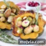 Roasted acorn squash halves, filled with brussels sprouts, cranberries and fresh rosemary