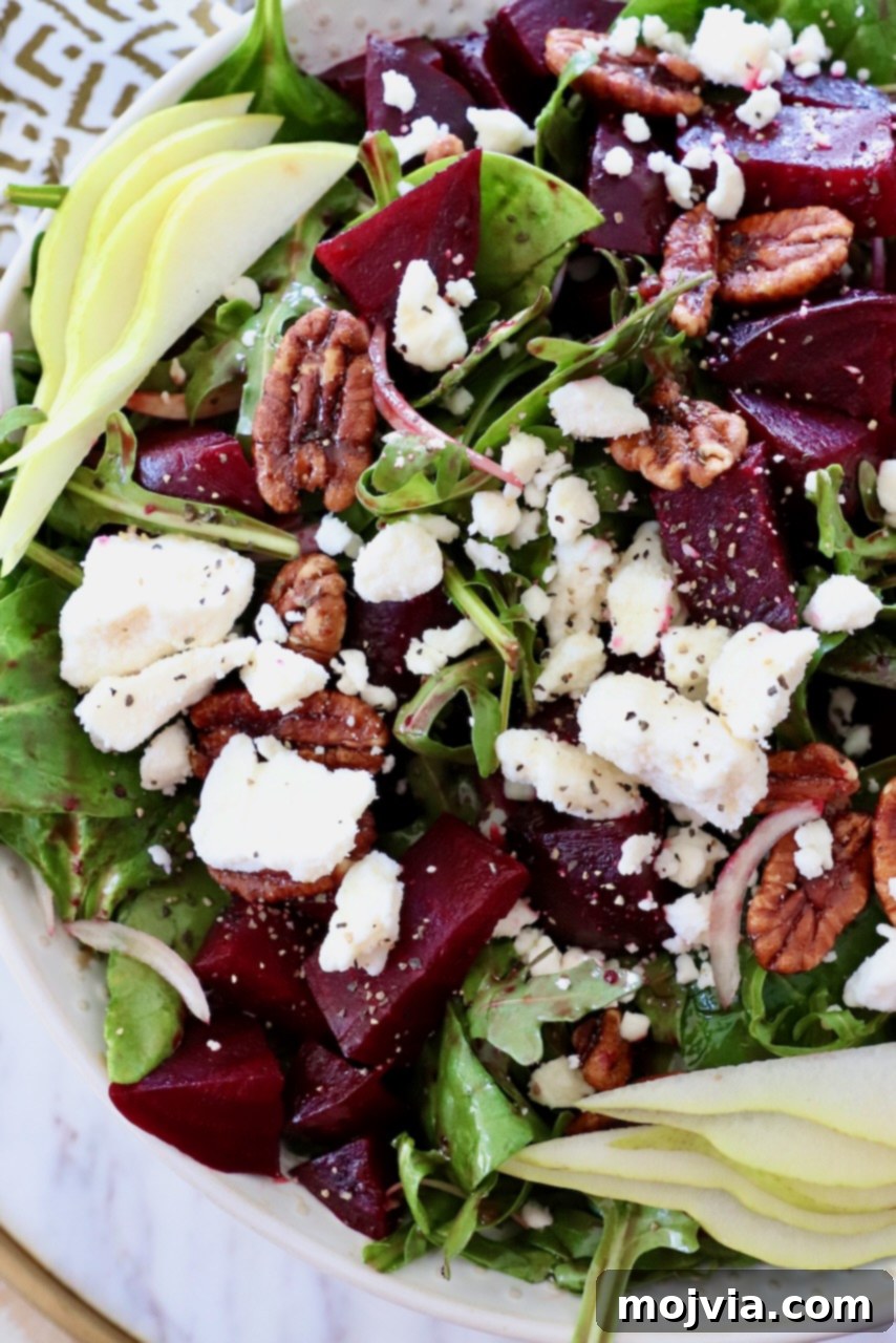 Ruby Beet Feta Salad 2 Vibrant beet salad in a bowl, topped with roasted beet cubes and crumbled feta cheese