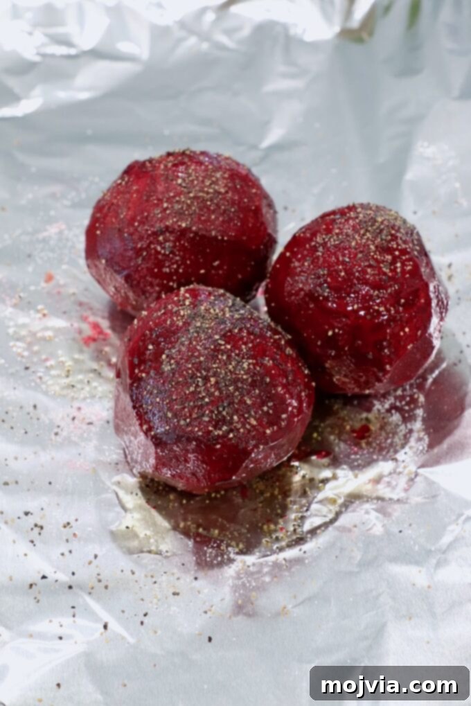 Ruby Beet Feta Salad 4 Peeled beets seasoned with olive oil, salt, and pepper on aluminum foil before roasting