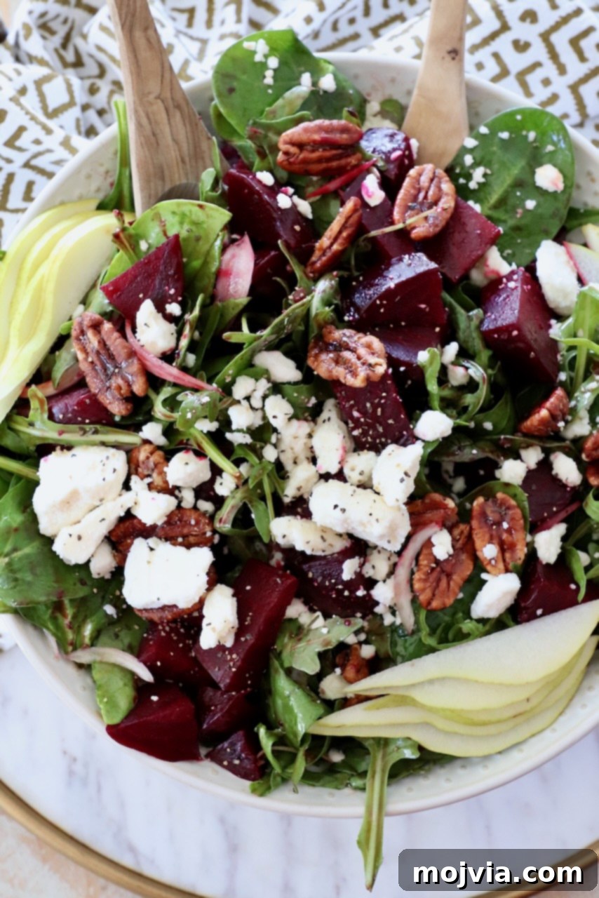 Ruby Beet Feta Salad 8 Large bowl of beet salad with serving spoons, showcasing the roasted beets and feta